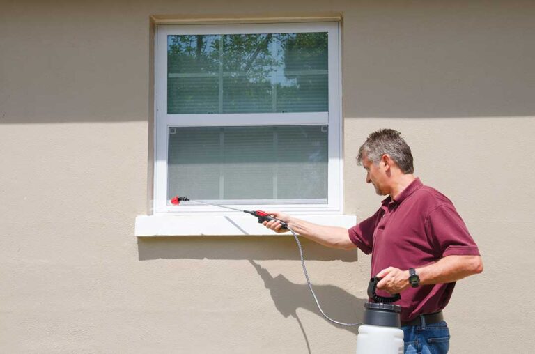 A living room outlet with a small electronic pest control device plugged in above a baseboard.